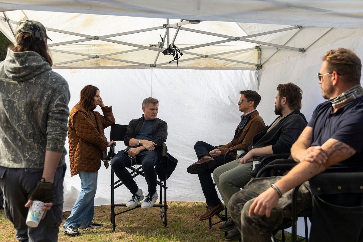 Cast and crew of The Waterfront discuss a scene during a break on set in North Carolina. (Image via Netflix)
